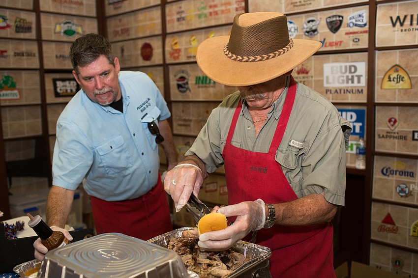 Jake Kelly from Nancy's Bar-B-Q serves a guest.