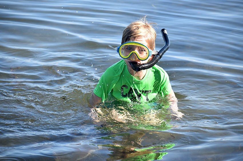Oliver Nichols takes a quick break from snorkeling.