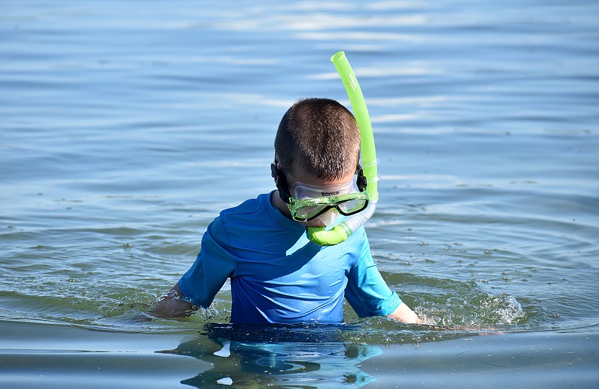Darren Eldred walks through the water.