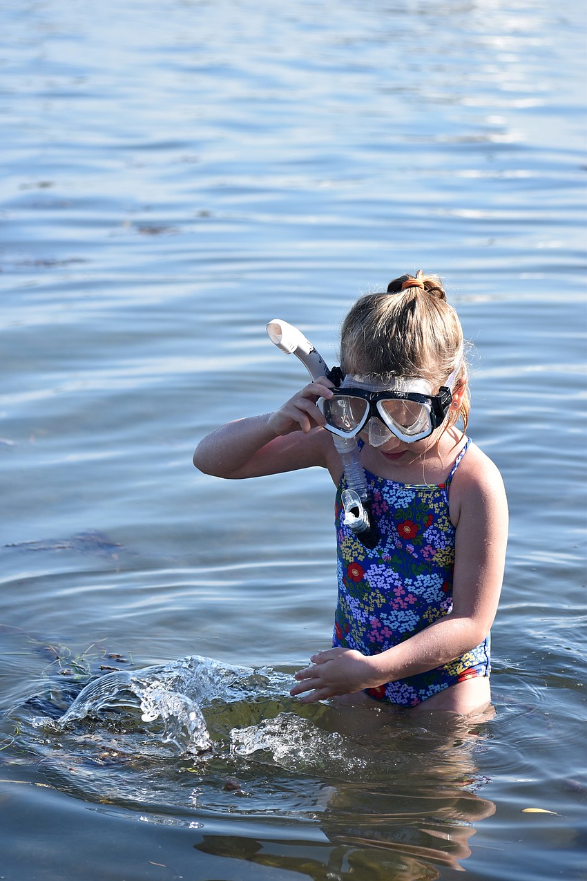 Cayden Stolarski splashes in the water.