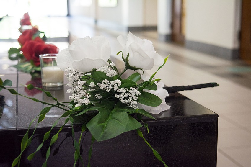 A white bouquet represented the 52 people injured in the attack.