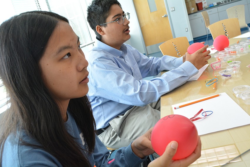 Pine View School students Grace Jiang and Ezekiel Pereira hold balloons to learn more about heart function.