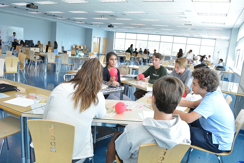 LECOM student Gizem Reyhanoglu, center, teaches campers about opioids and other drugs and their impact on the body.