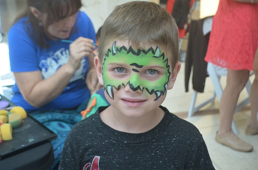 Parrish resident Jackson Stoles, 5, says he got a dragon painted on his face because it 