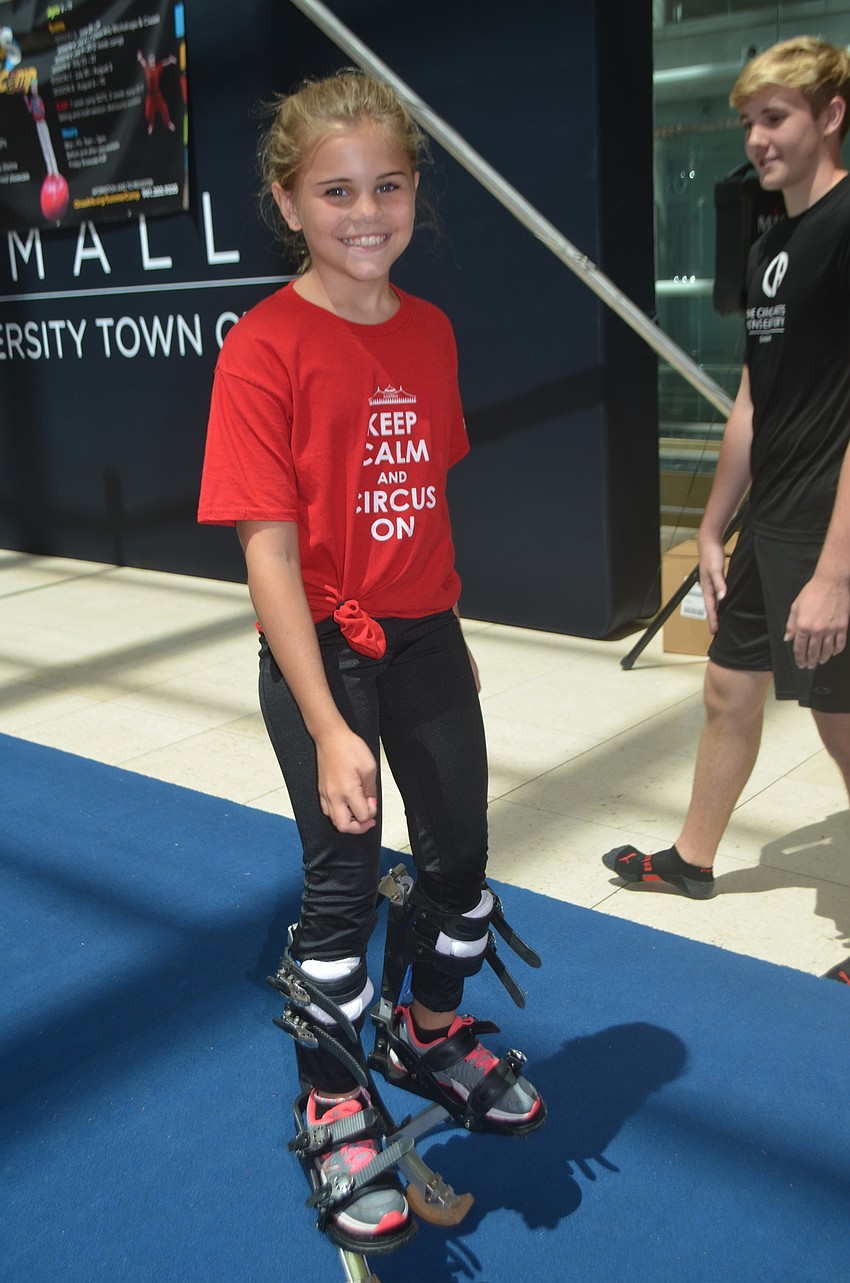 Sailor Circus Academy performer Callahan Harchuck, 10, walks around the Circus Day festivities on stilts.