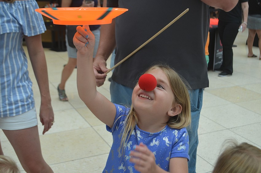 Parrish's Reese Phillips, 5, enjoys balancing the plate on one finger as it spins.
