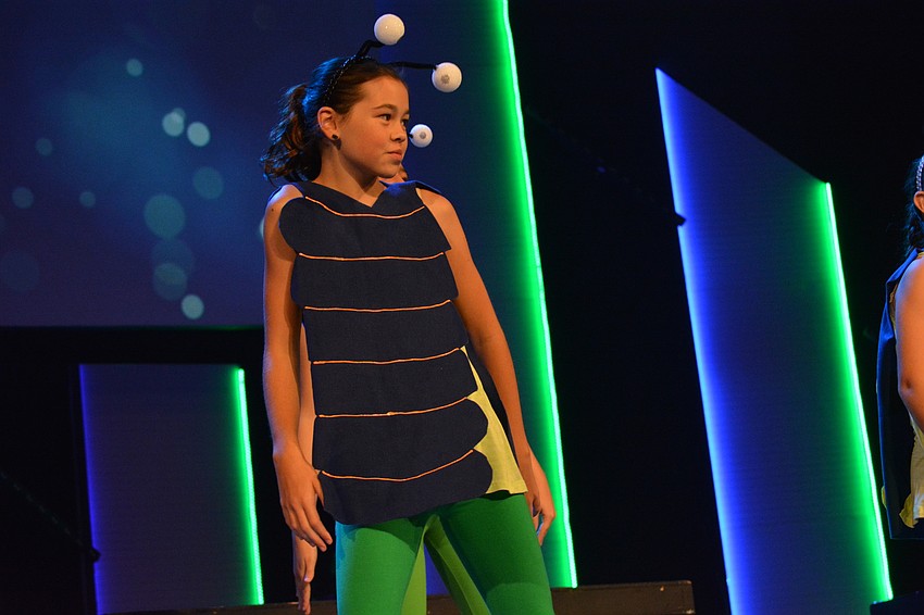 Kayleigh Lollar dances backup to the Caterpillar as he sings 