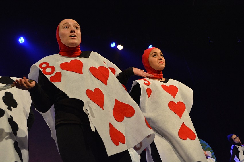 Madison George and Lauren Medred paint the roses red for the Queen.