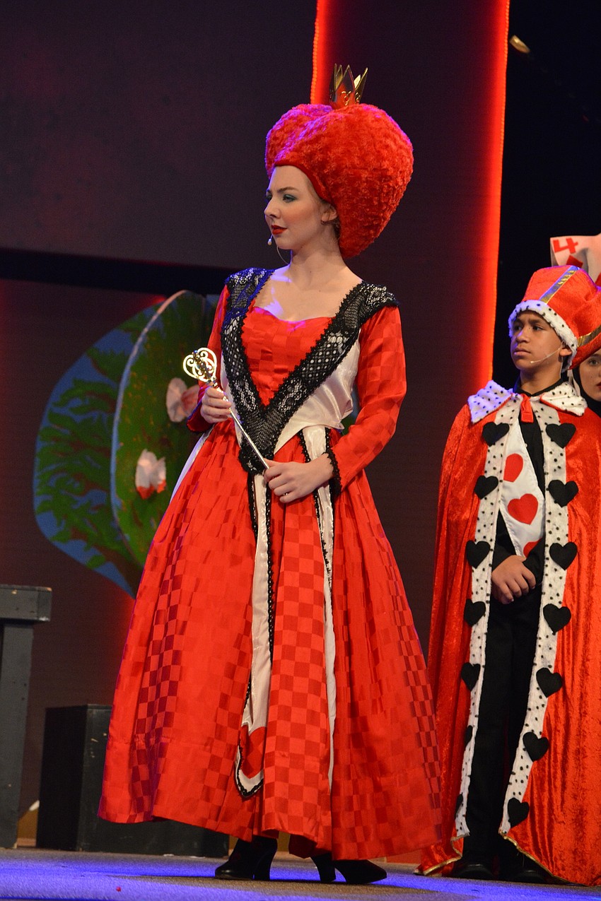 Queen of Hearts (Anna Landis) challenges Alice to a game of Simon Says.