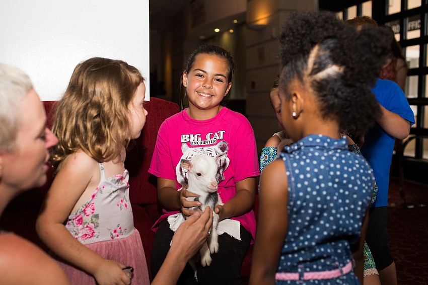 Sydney Smith smiles for a photo with Snowball.
