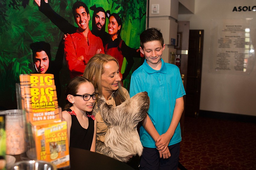 Mairead and Liam Farrelly pose for a photo with the sloth.
