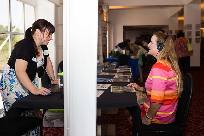 Kerrie Sobering listens to animal sounds, played by Sam Valentin.