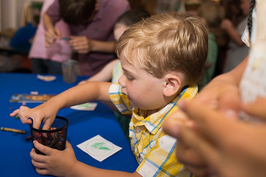 Brock Austin colors his button.