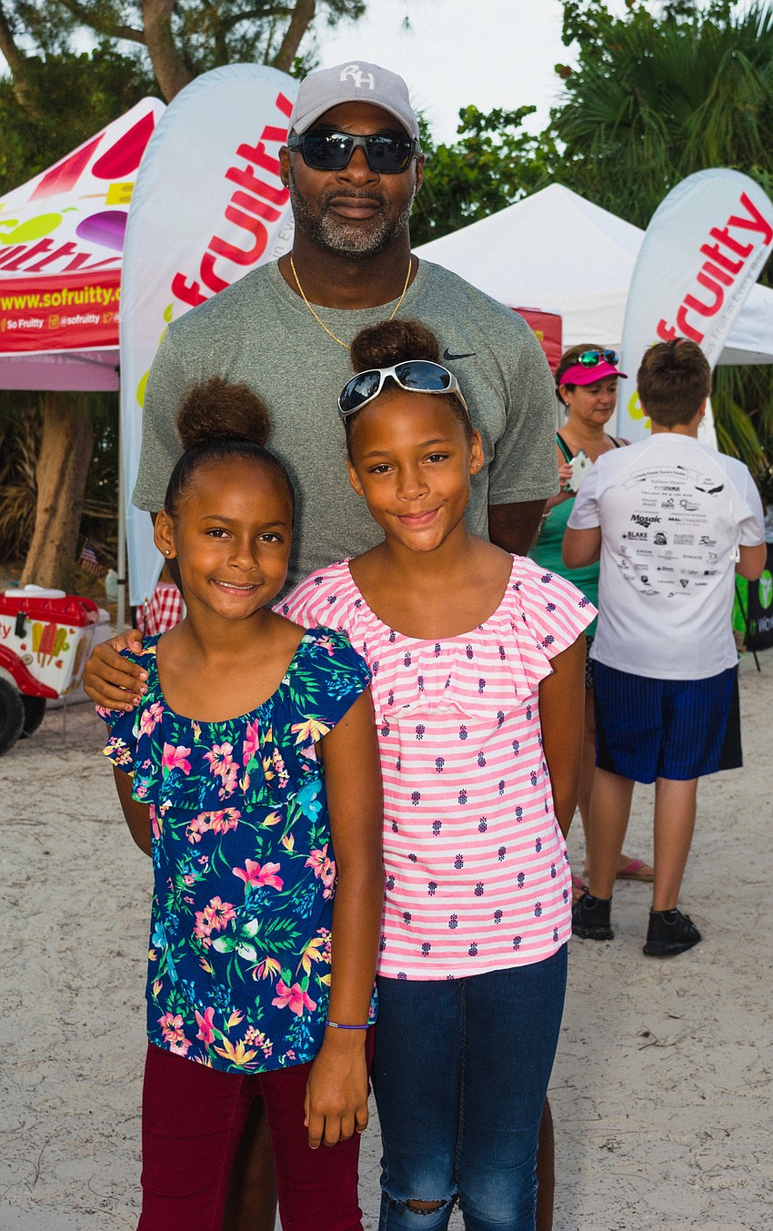 Kazmiere and Anya Harris with their father, Robert.