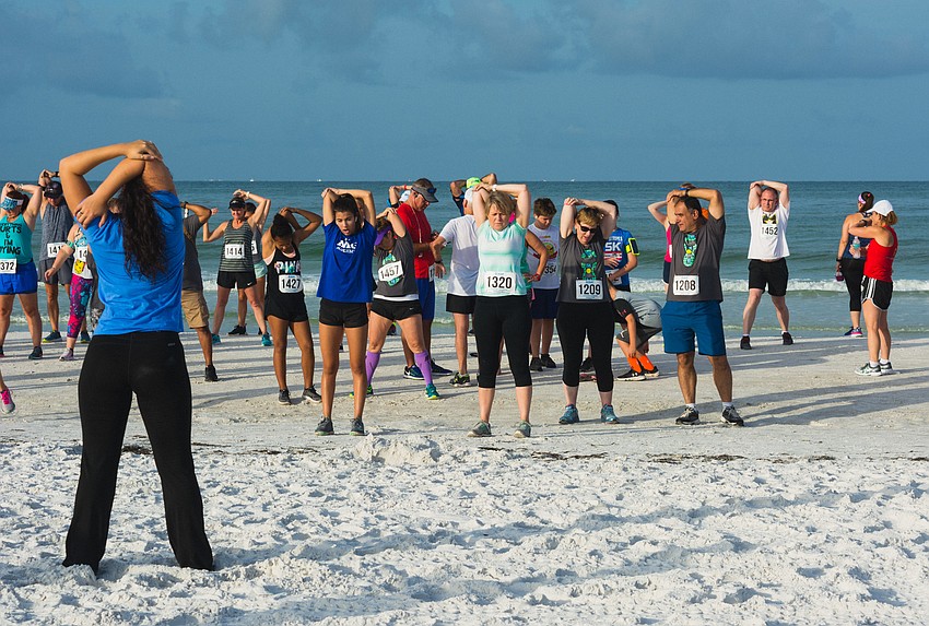 Runners do some stretches before the big race.