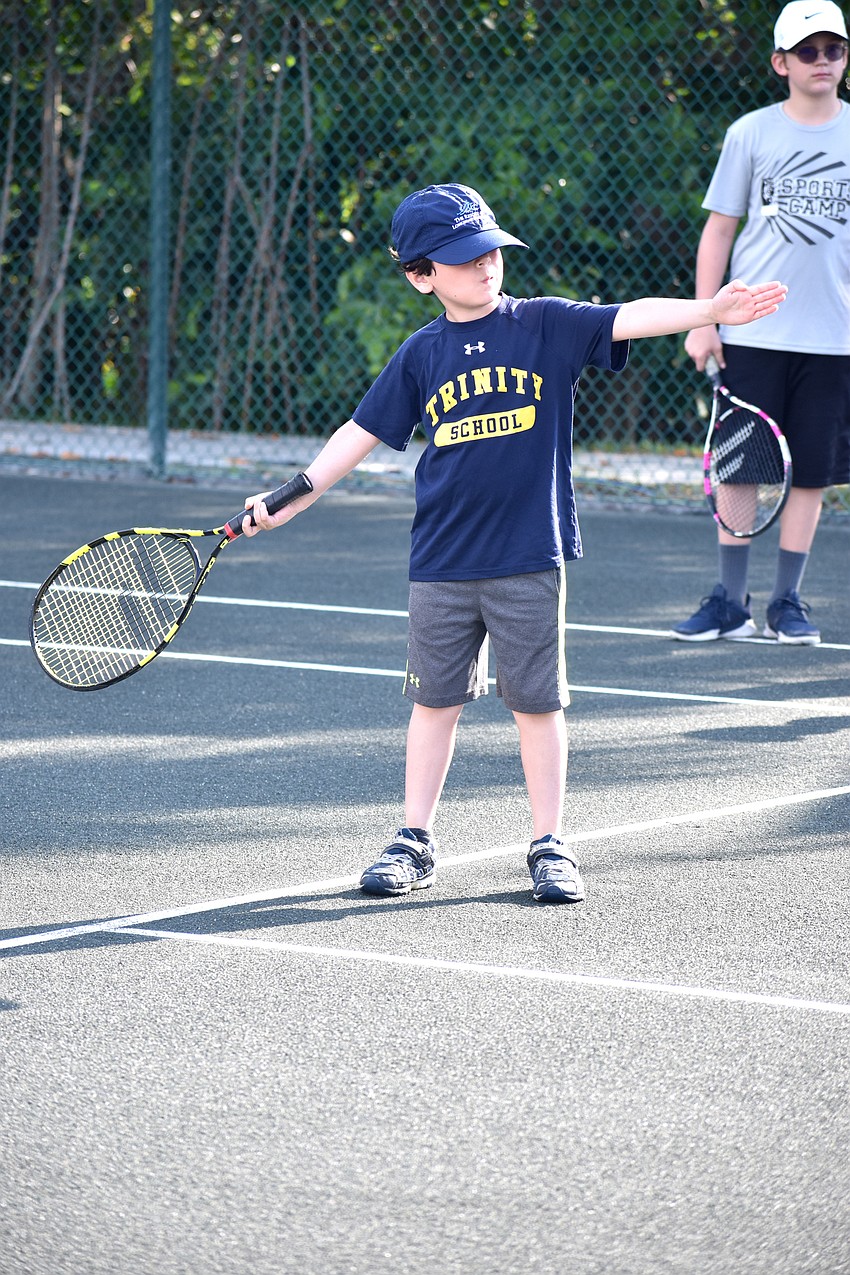 Teddy Brody practices moving the racket in the correct angle.
