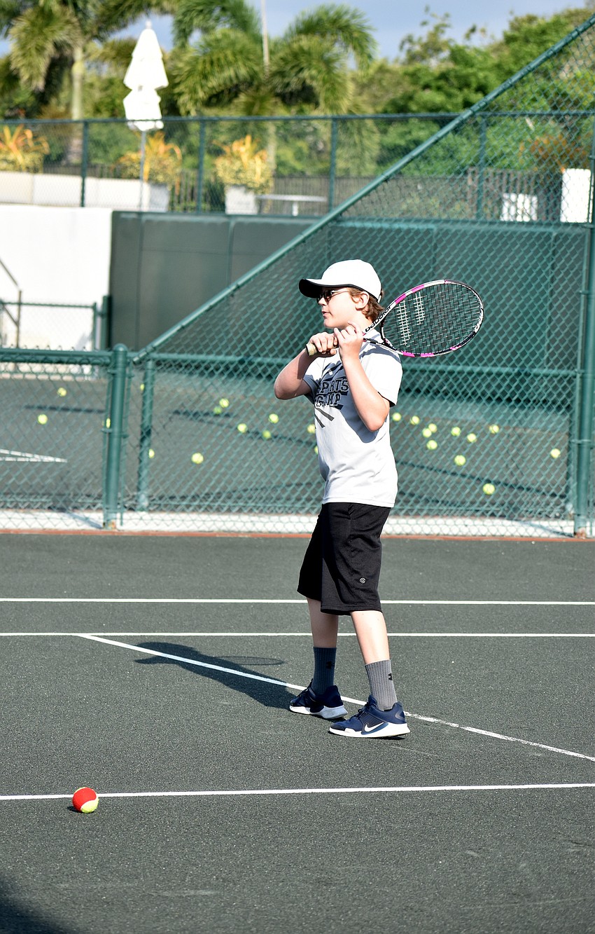 Ben Kruse watches the ball he hit fly over the net.