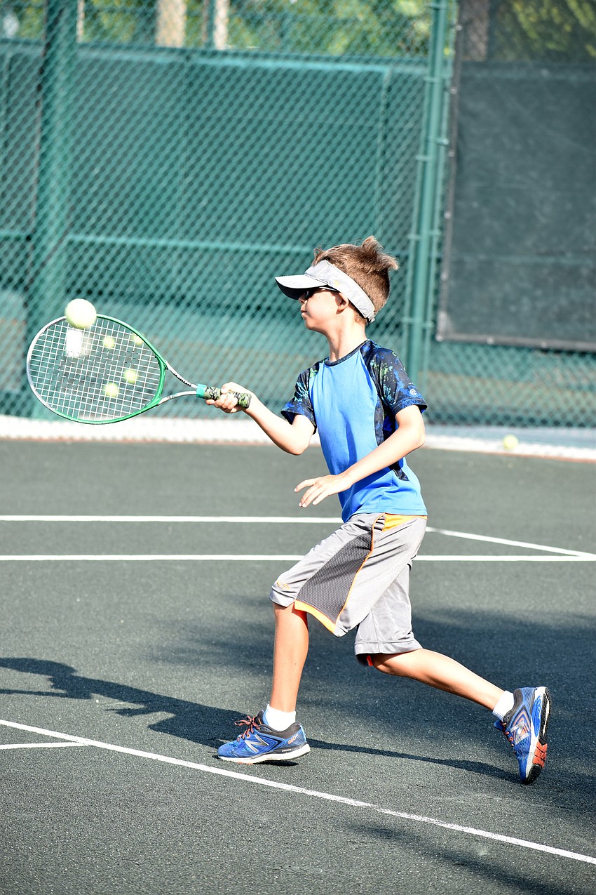 Tristan Abrams returns the ball during a summer camp drill.