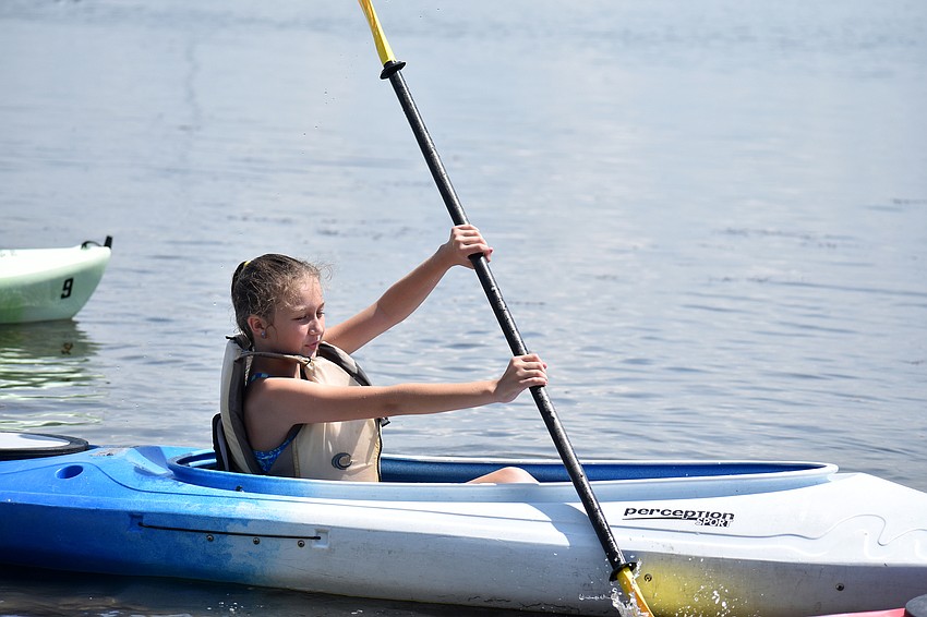 Autumn Boehm paddles out on the Sarasota Bay water.