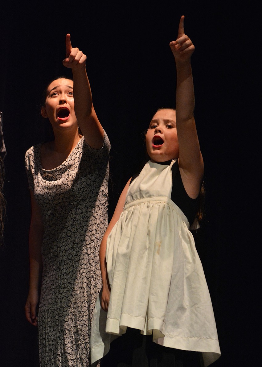 Counselor Gabby Macogay and Ainsley Young, as Doreen Driggles, point as the giant peach heads their way.