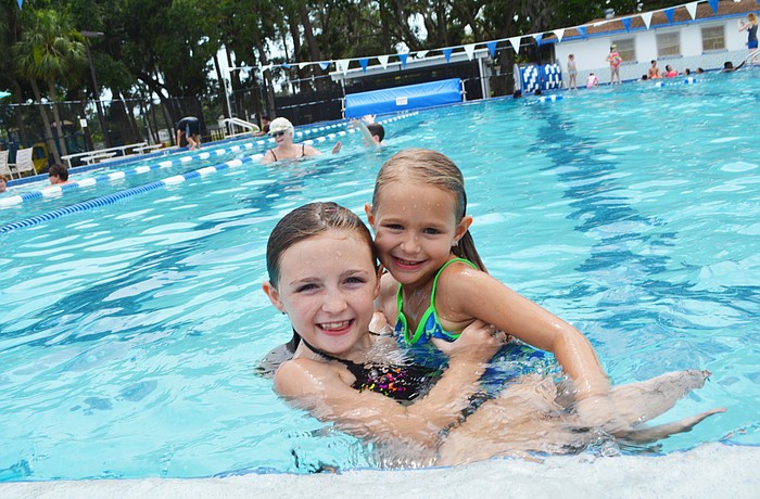 Freedom Elementary's Jordan Michaelin tosses her friend Eleanor Ietermend in the pool at John H. Marble Park with a splash. They have fun cooling off.