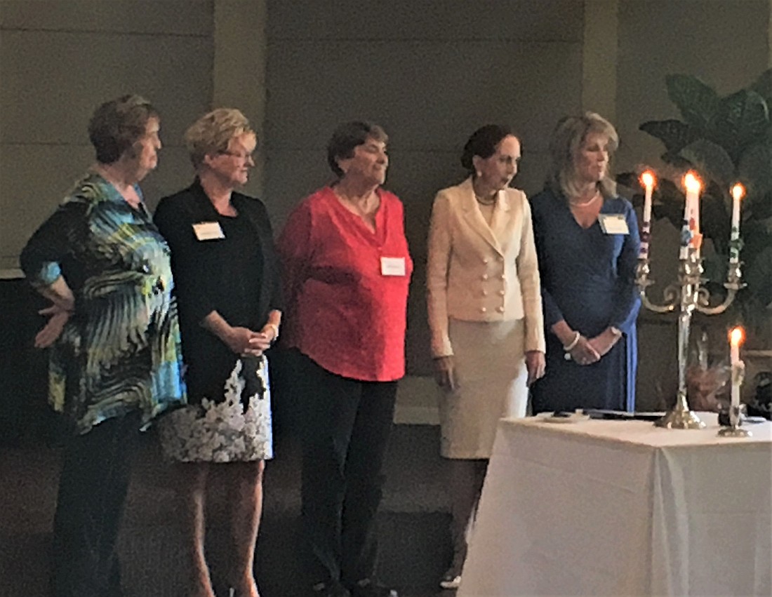 The 60th anniversary PAWC board â€” Janice Scanlon, Kim Lege, Judy Bouchard, Susan Romine and President Patti Hernandez â€” is installed during a candlelit ceremony.  Photo courtesy of Meg Garofalo.