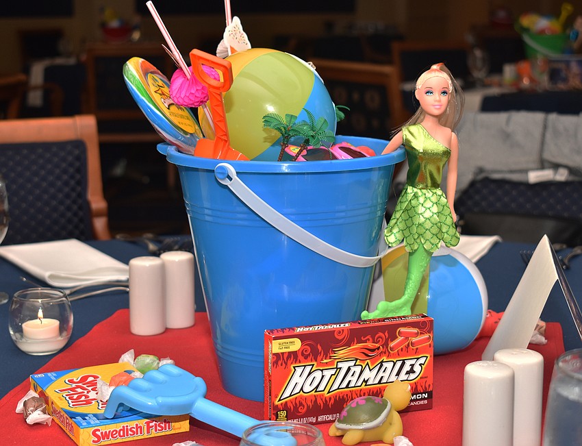 Each table had a bucket and other summer items in the center.