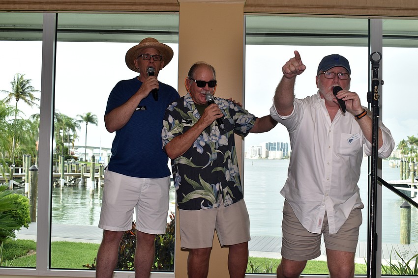 Bob Williams, Curt Schantz and Mark Muse sing “Sweet Caroline.”