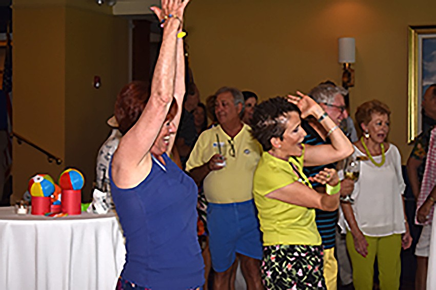 Carol Patulo and Michele Fischman dance to “YMCA.”