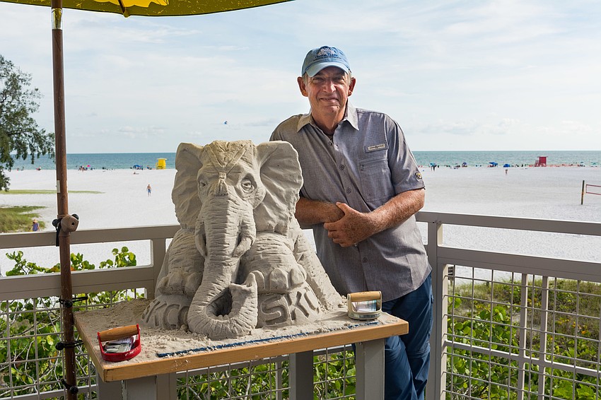 Brian Wigelsworth with a sand sculpture he created for the event.