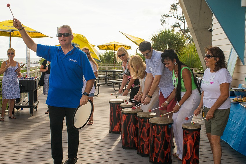 Erik Dunton leads participants in a group drumming activity.