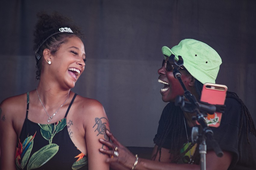 Amber Gilliam, left, and a friend dance on stage with Jah Movement.