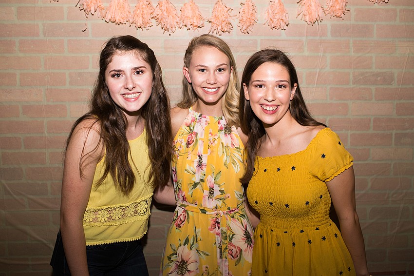 Fundraiser event organizers Morgan Campbell and Emma Johnson with   Isabella Smith, center.