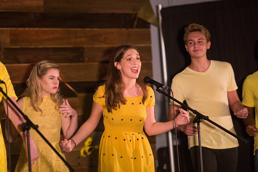 Performers Taylor Reister, Emma Johnson and Jonah Dushesne-Shaw wear yellow, Isabella Smith's favorite color.