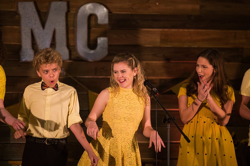 Danny Bó Delongaig, Taylor Reister, and Emma Johnson perform during a benefit concert for their classmate Isabella Smith.