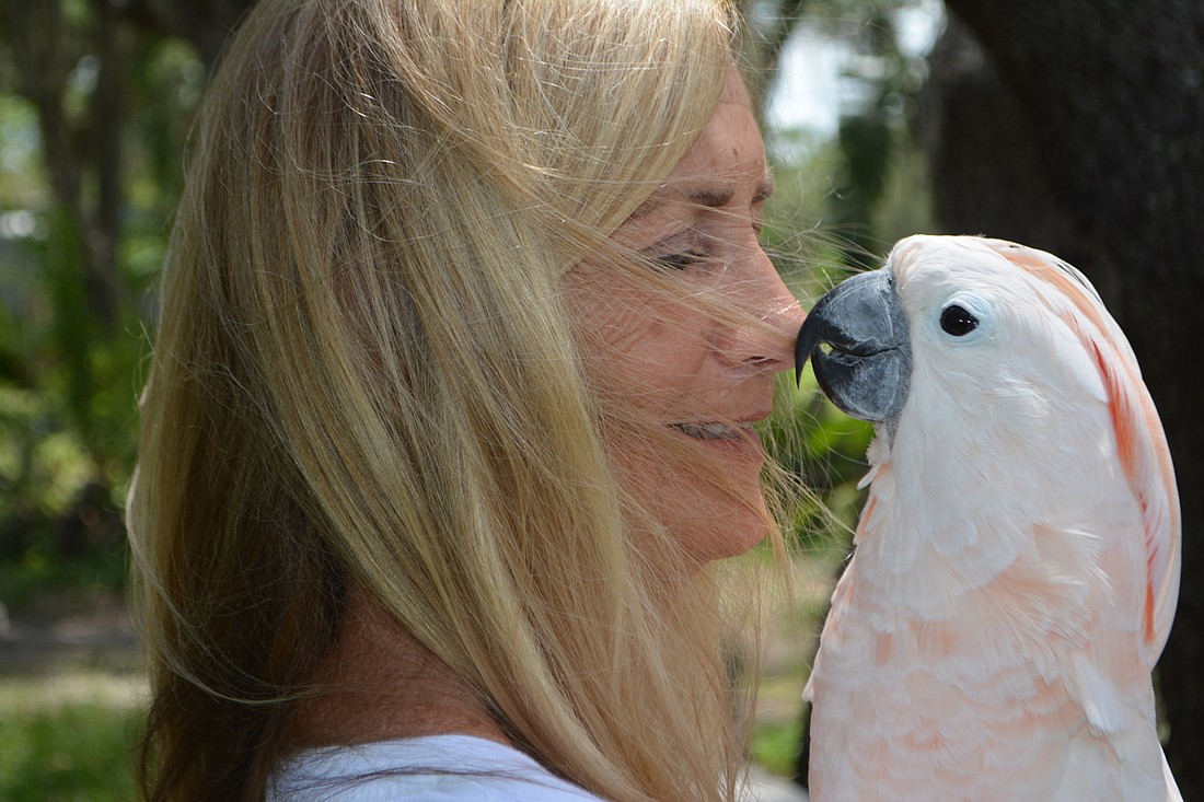 Debbie Huckaby with Aquiel, a Moluccan Cockatoo