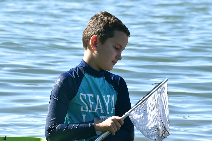 Trip McEachern scopes out the findings in his net.