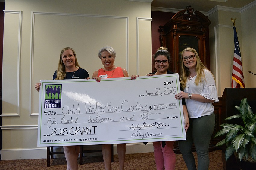 Child Protection Center's Jessica McSwain poses with Sisterhood member Theodora Stern and fellow CPC representatives Ariane Beauchamp and Shelby Marsh.