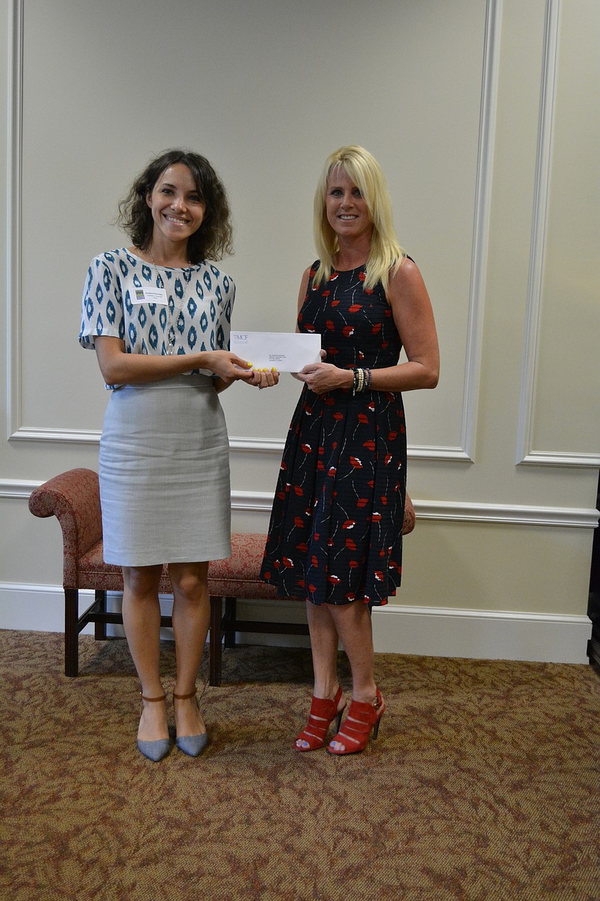 Children’s Guardian Fund representative Svetlana Kaminsky, poses with Sisterhood member Kecia Dorsey.