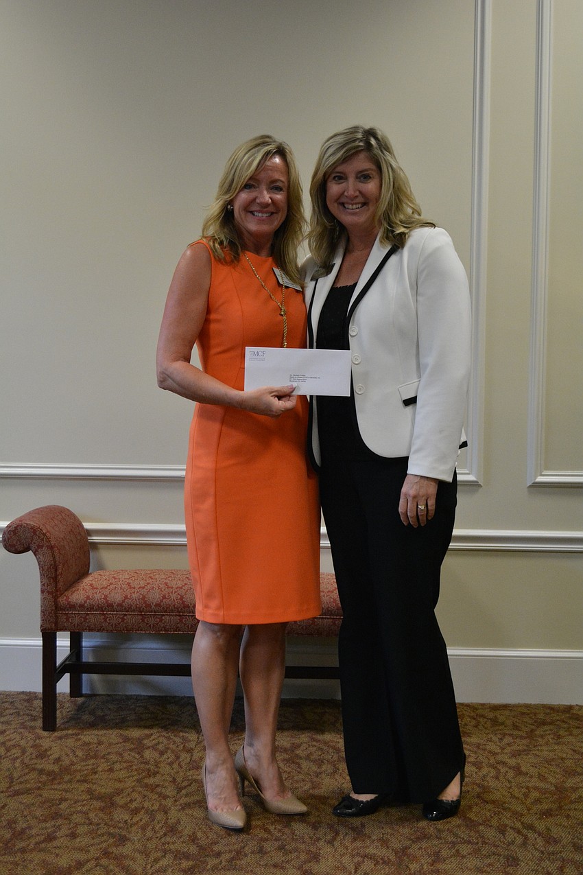 Meals on Wheels PLUS Vice President of Development Diana Dill accepts a $1,054 grant from Sisterhood member Heather Kasten. The funds will be used for The Food Bank of Manatee’s emergency intervention programs.