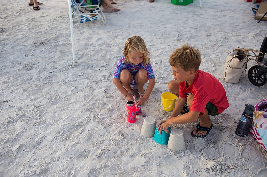 Kelsey and RJ Lodge make sandcastles.