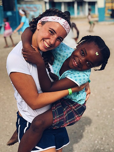 Rachel Consiglio plays with students in Jamaica as part of her service work on the trip. Courtesy photo.