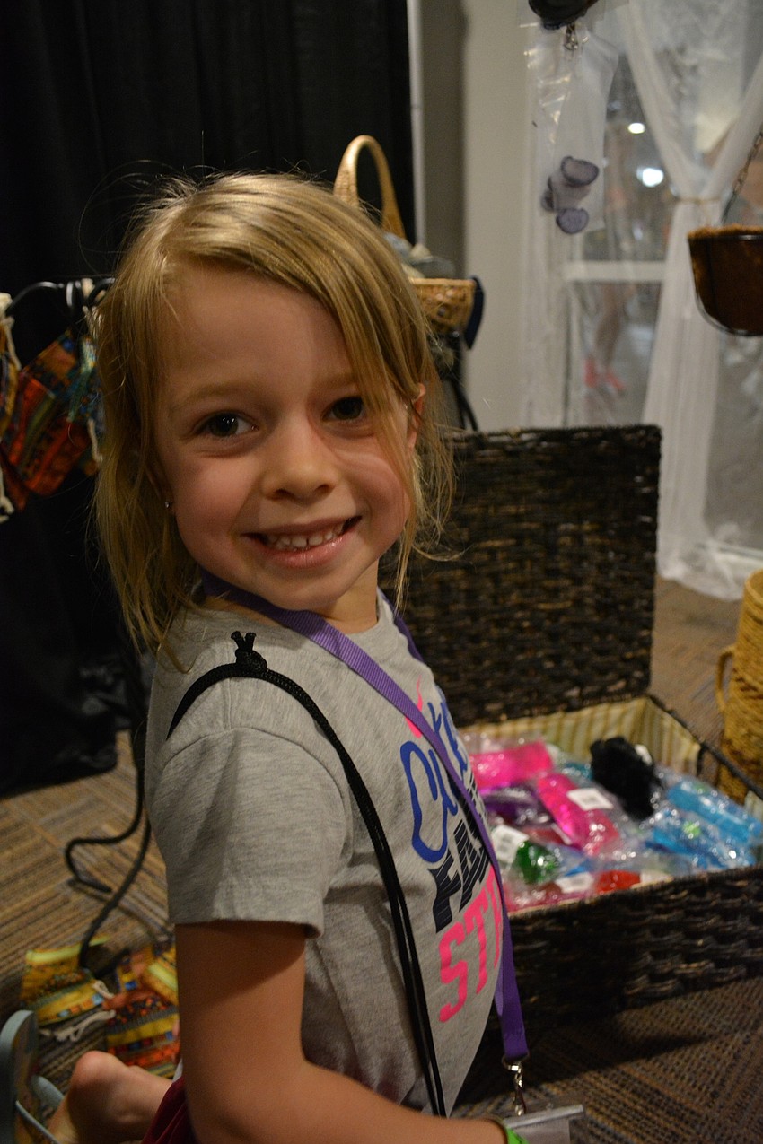 Six-year-old Kinsie Reith picks out a prize from the Cairo Marketplace.