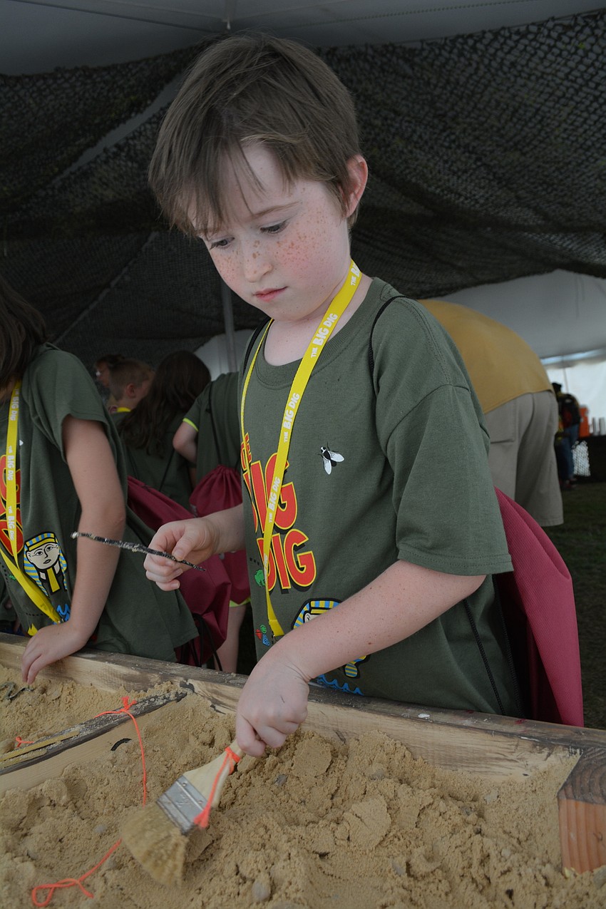 East County's Joshua Callahan, 7, finds a plastic snake on an archaeological dig.