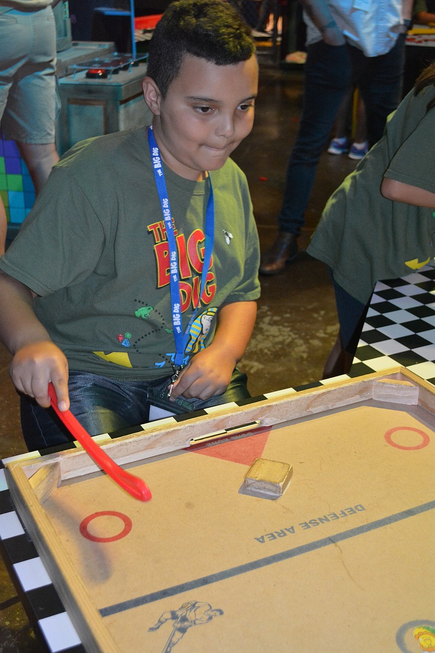 Heritage Harbour resident Lucas Mllan, 9, plays nok hockey with his sister, volunteer Charlize Millan, not pictured.
