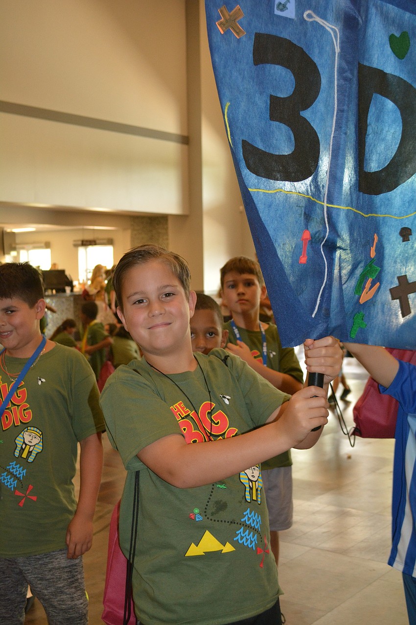 East County's Christian Lazo, 8, leads his third-grade group proudly.