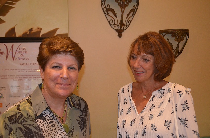 Rita Probst and Rosella Gray look through the raffle items.