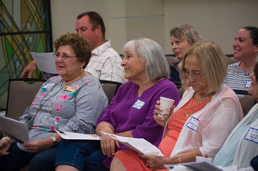 Attendees get ready to sing along during the ceremony.