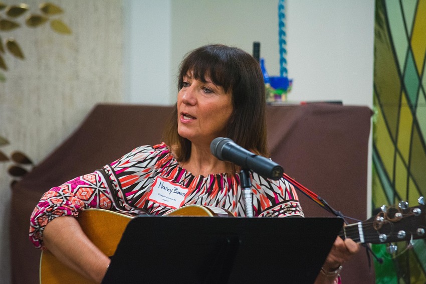 Nancy Bossov leads singers into a song with a wordless melody.