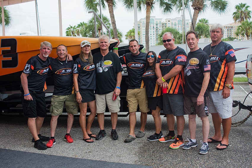 Members of the AMH Motorsports Offshore Racing Team pose near their boat.